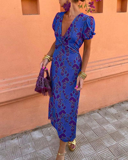 Elegant A-line dress with leaf print, deep V-neck, and puff sleeves