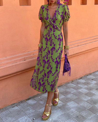 Elegant A-line dress with leaf print, deep V-neck, and puff sleeves