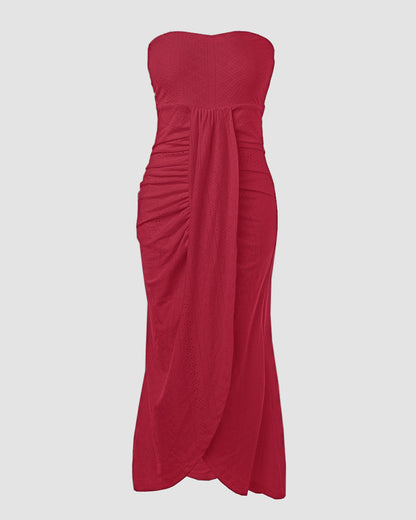 Sleeveless ruched vacation dress with a cinched waist, a draped bandeau-style bodice, eyelet embroidery, a slit, and an asymmetrical hem