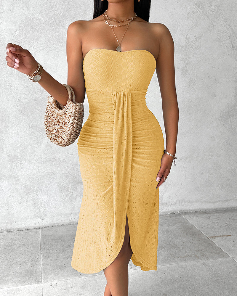 Sleeveless ruched vacation dress with a cinched waist, a draped bandeau-style bodice, eyelet embroidery, a slit, and an asymmetrical hem
