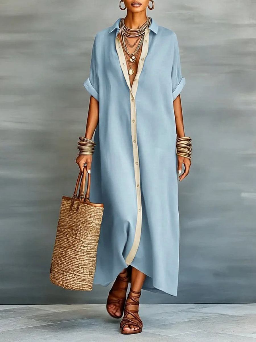 Long dress with lapels, short ample sleeves, with buttons, pockets and slit seams