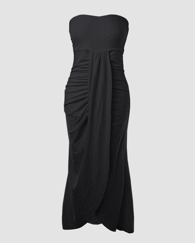 Sleeveless ruched vacation dress with a cinched waist, a draped bandeau-style bodice, eyelet embroidery, a slit, and an asymmetrical hem