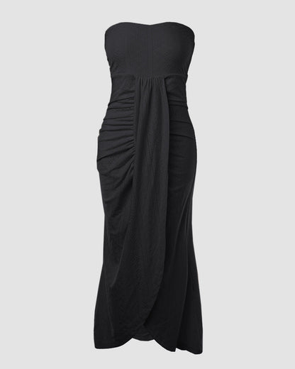 Sleeveless ruched vacation dress with a cinched waist, a draped bandeau-style bodice, eyelet embroidery, a slit, and an asymmetrical hem