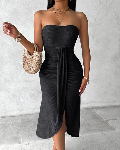 Sleeveless ruched vacation dress with a cinched waist, a draped bandeau-style bodice, eyelet embroidery, a slit, and an asymmetrical hem