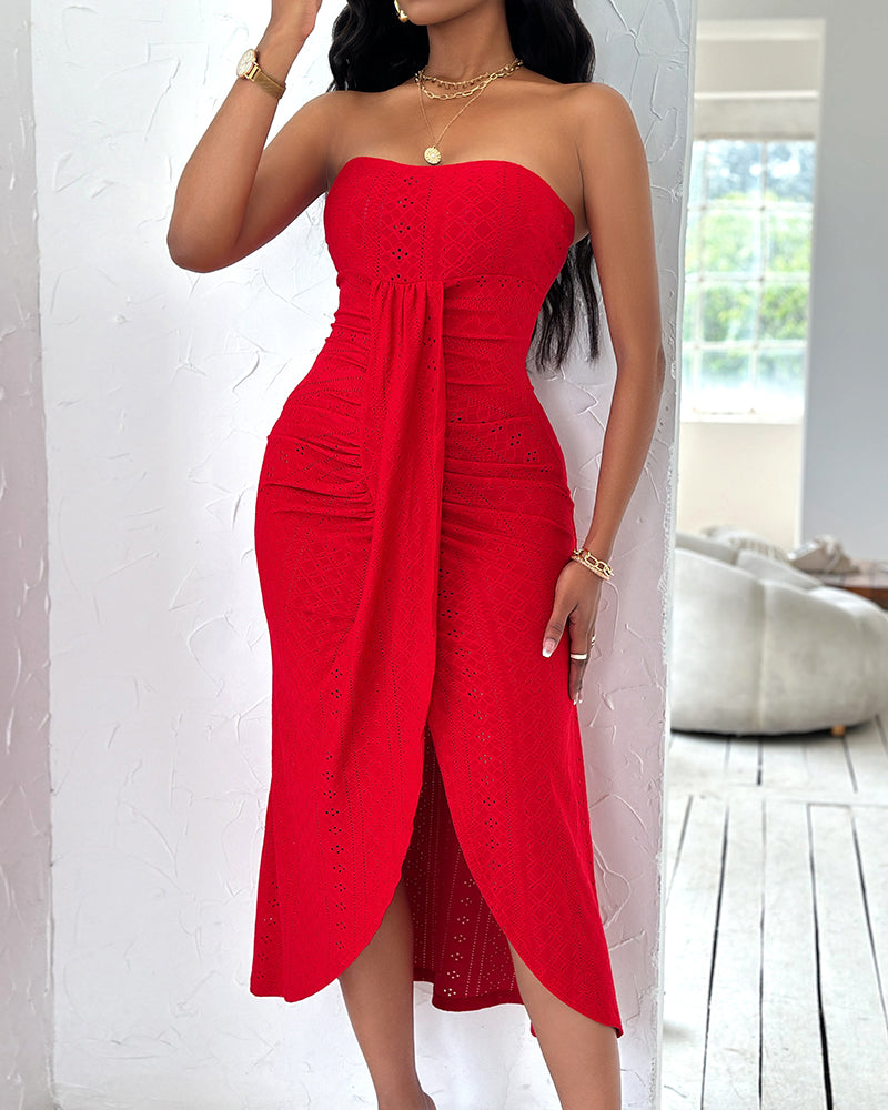 Sleeveless ruched vacation dress with a cinched waist, a draped bandeau-style bodice, eyelet embroidery, a slit, and an asymmetrical hem