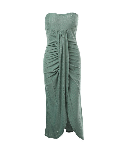 Sleeveless ruched vacation dress with a cinched waist, a draped bandeau-style bodice, eyelet embroidery, a slit, and an asymmetrical hem