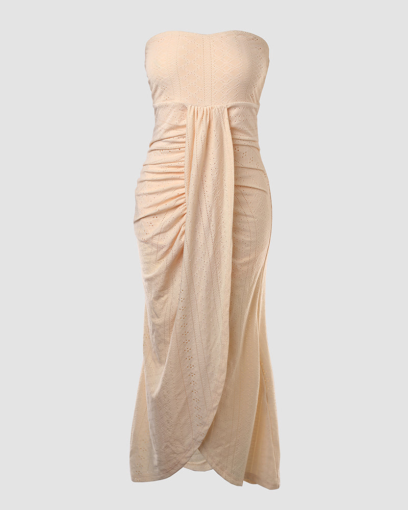 Sleeveless ruched vacation dress with a cinched waist, a draped bandeau-style bodice, eyelet embroidery, a slit, and an asymmetrical hem