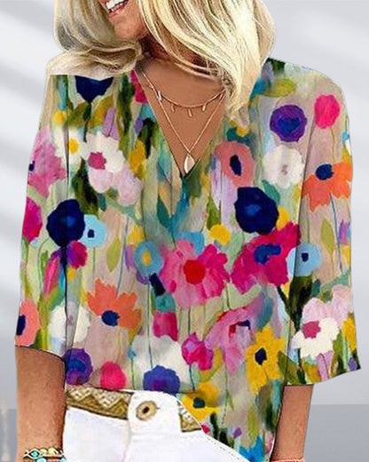 Casual V-neck, three-quarter sleeve top with a colorful floral print