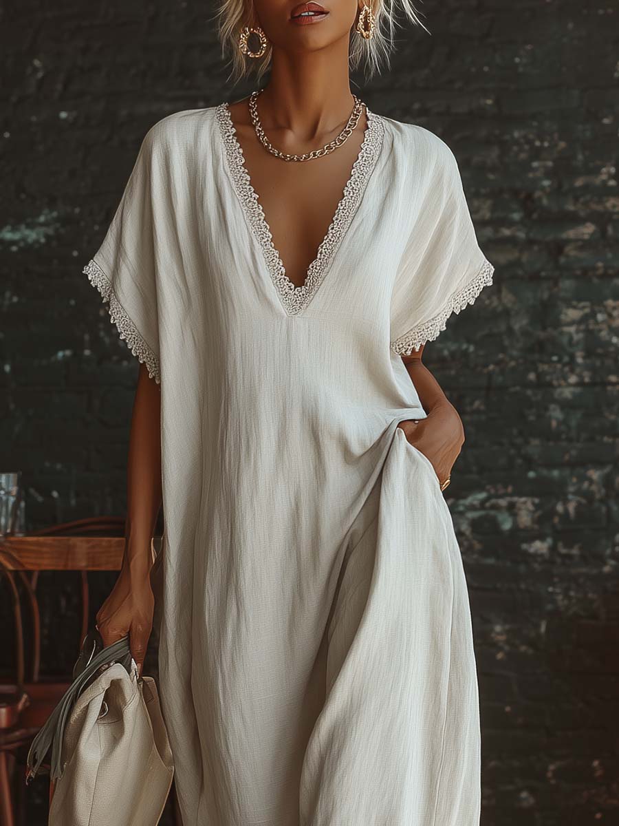 Urban white cotton maxi dress with a V-neck, short sleeves, and lace trim, casual bohemian style