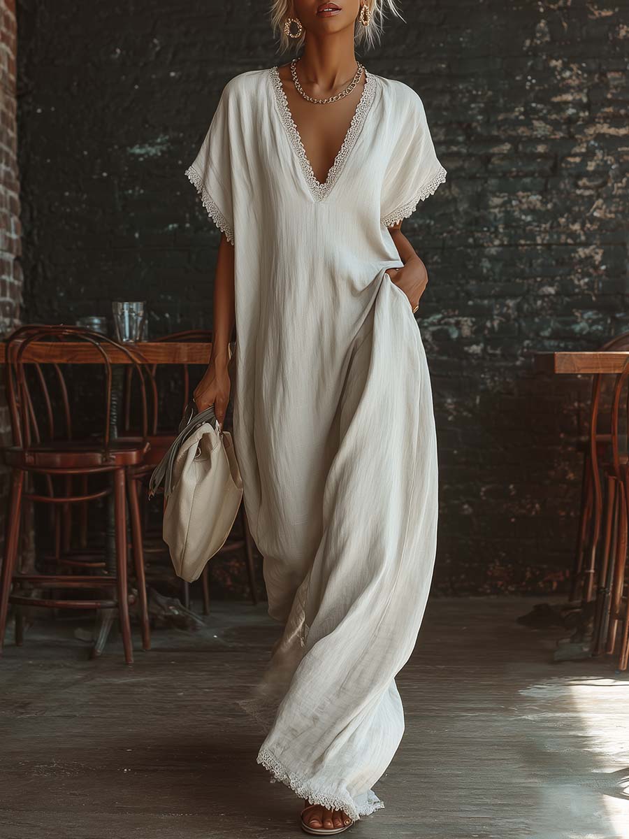 Urban white cotton maxi dress with a V-neck, short sleeves, and lace trim, casual bohemian style