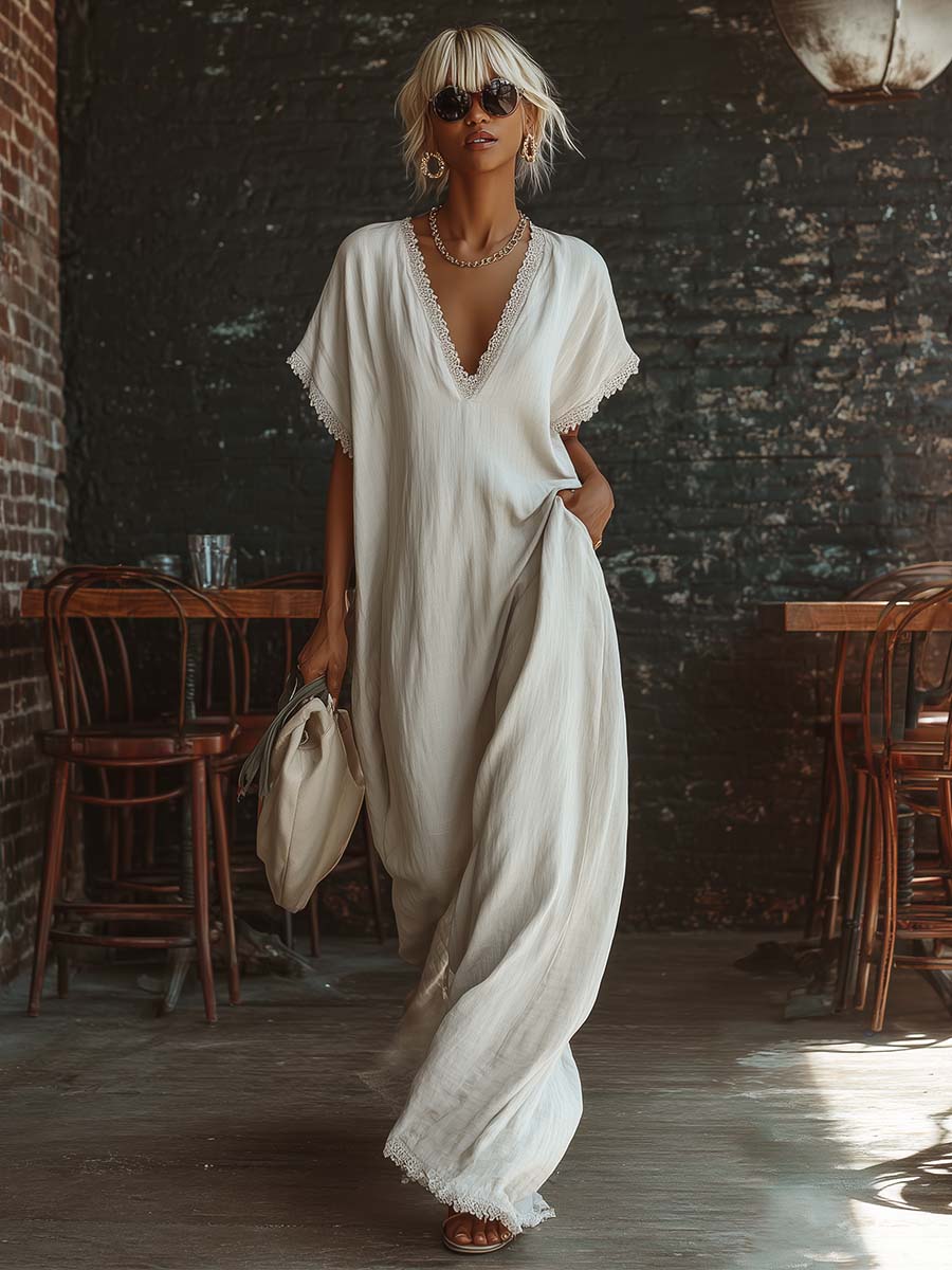 Urban white cotton maxi dress with a V-neck, short sleeves, and lace trim, casual bohemian style