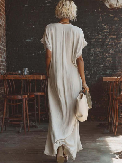 Urban white cotton maxi dress with a V-neck, short sleeves, and lace trim, casual bohemian style