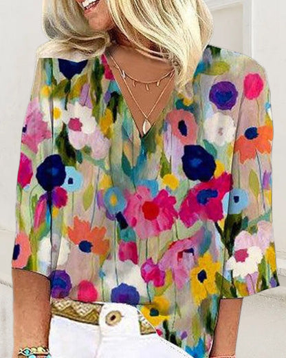 Casual V-neck, three-quarter sleeve top with a colorful floral print