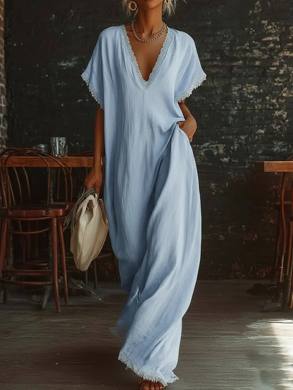 Urban white cotton maxi dress with a V-neck, short sleeves, and lace trim, casual bohemian style