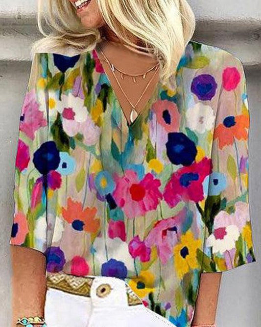 Casual V-neck, three-quarter sleeve top with a colorful floral print
