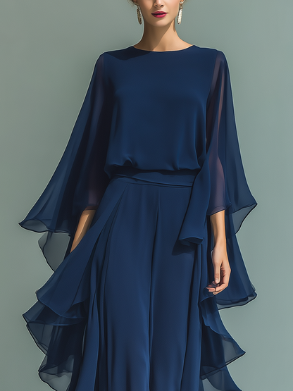 Women's set consisting of a navy blue chiffon top with flared sleeves and straight pants with ruffled details