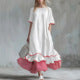 Robe longue ample en lin à rayures passepoilées et ourlet à volants