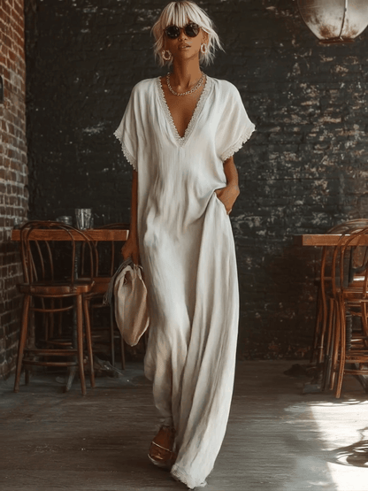 Urban white cotton maxi dress with a V-neck, short sleeves, and lace trim, casual bohemian style
