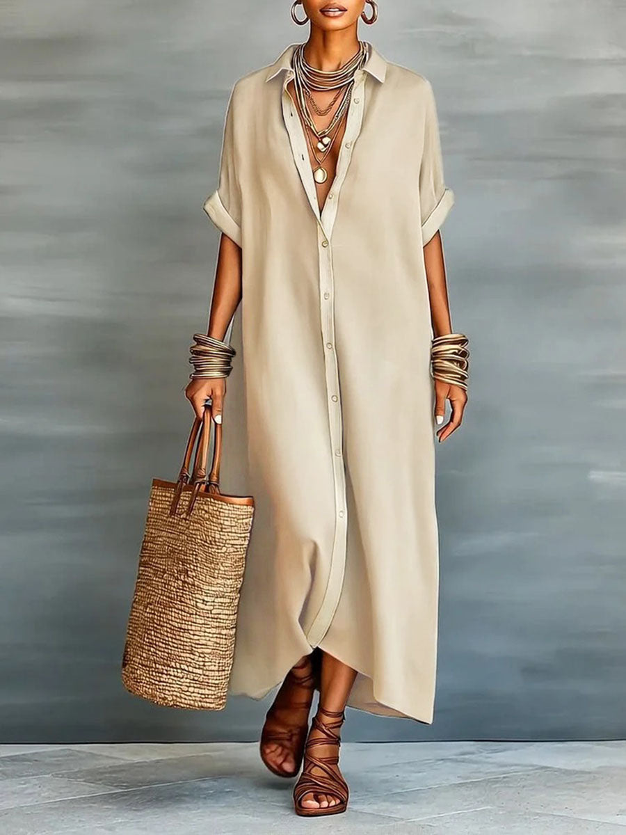 Long dress with lapels, short ample sleeves, with buttons, pockets and slit seams