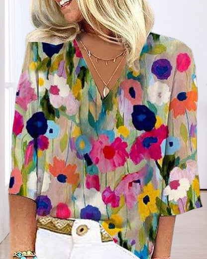 Casual V-neck, three-quarter sleeve top with a colorful floral print