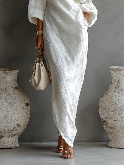 Elegant white one-shoulder maxi dress with flowing ruffles