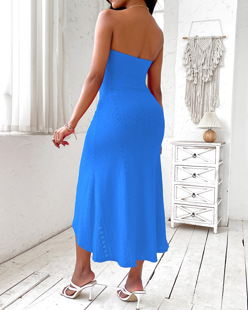 Sleeveless ruched vacation dress with a cinched waist, a draped bandeau-style bodice, eyelet embroidery, a slit, and an asymmetrical hem