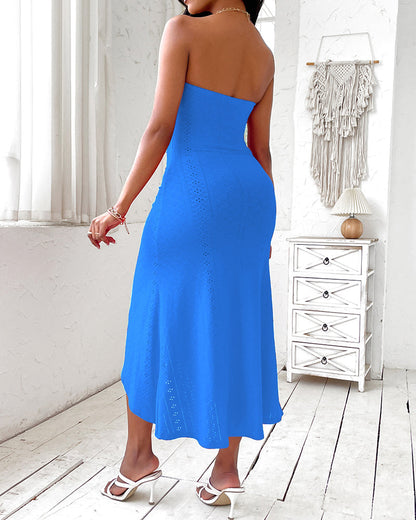 Sleeveless ruched vacation dress with a cinched waist, a draped bandeau-style bodice, eyelet embroidery, a slit, and an asymmetrical hem