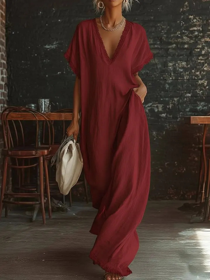 Urban white cotton maxi dress with a V-neck, short sleeves, and lace trim, casual bohemian style