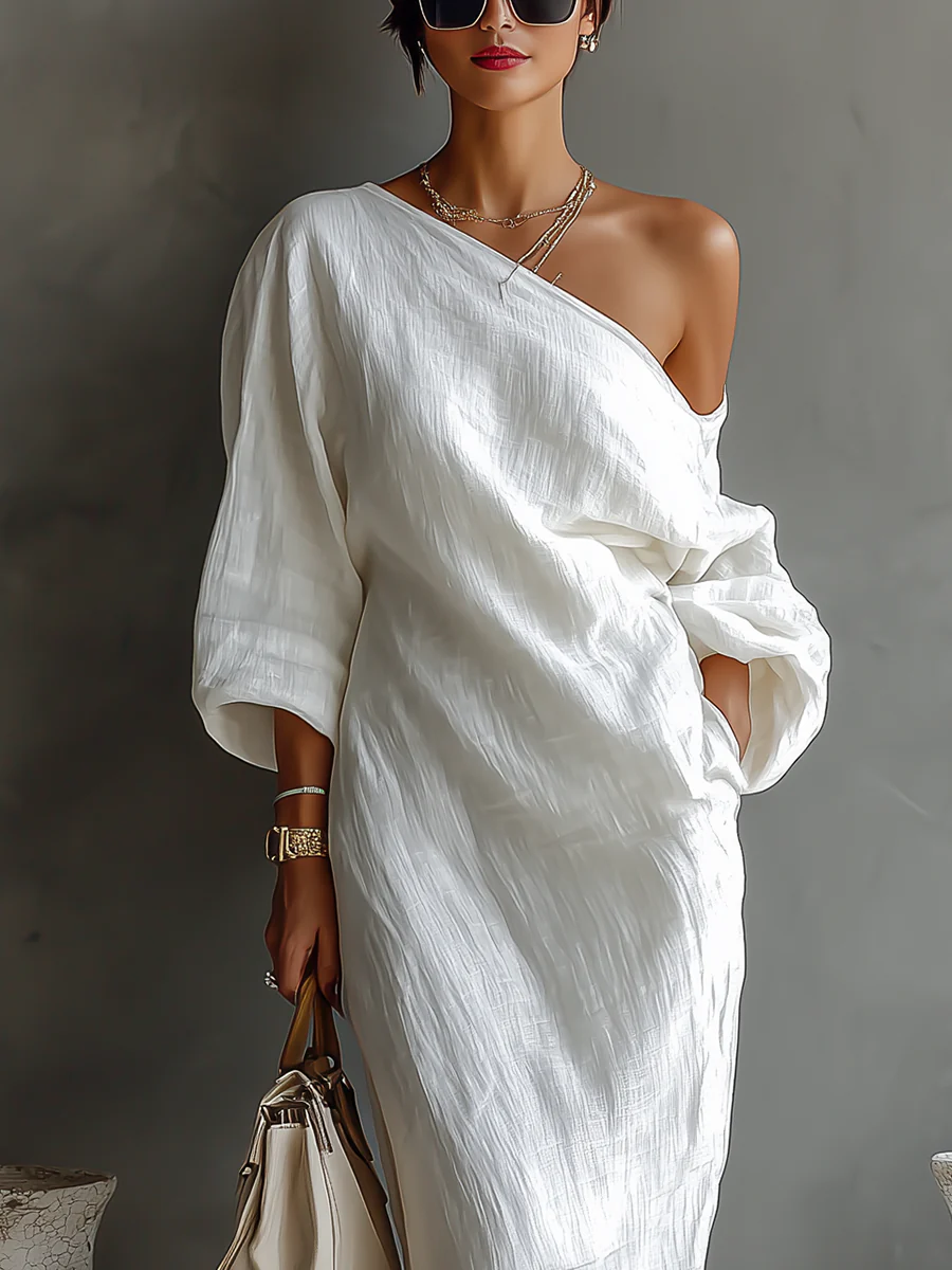Elegant white one-shoulder maxi dress with flowing ruffles
