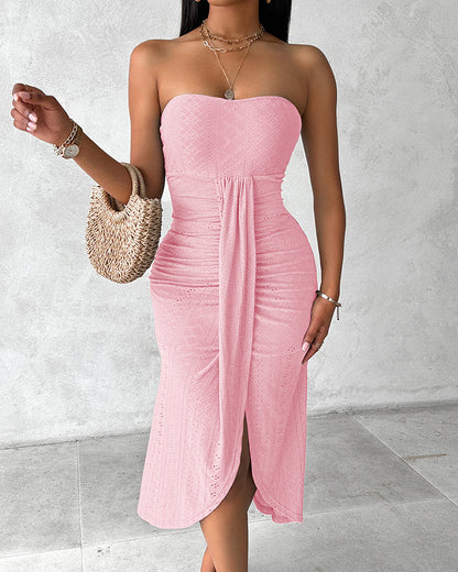 Sleeveless ruched vacation dress with a cinched waist, a draped bandeau-style bodice, eyelet embroidery, a slit, and an asymmetrical hem